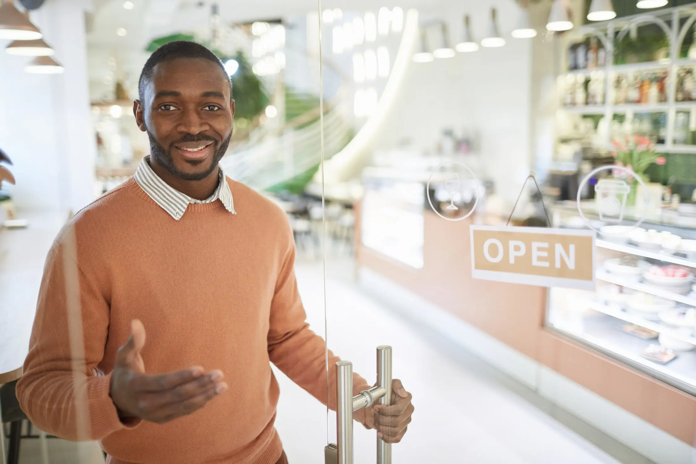 Shop owner opening an outlet, representing the move from one owner-managed shop to several branches