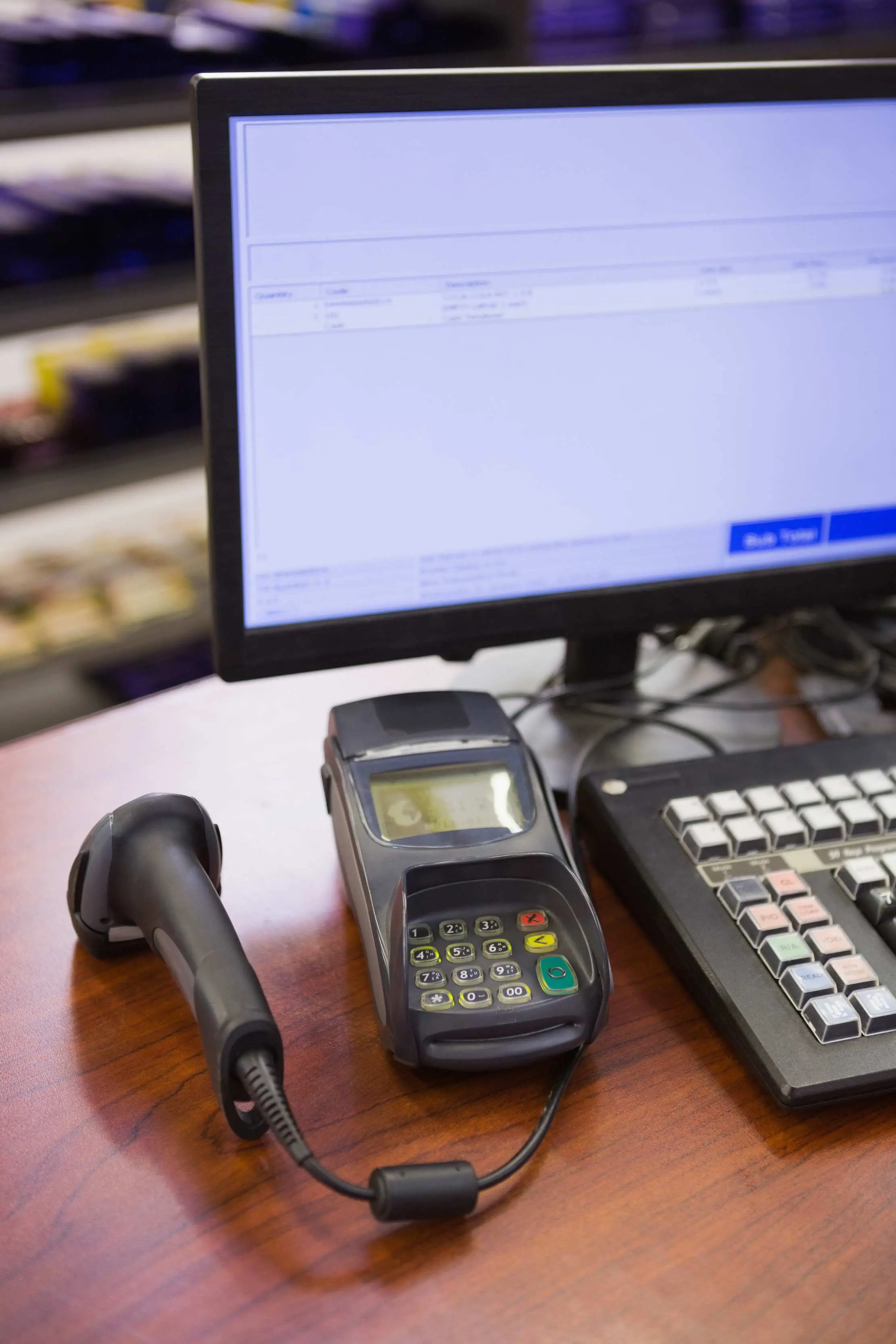 Retail checkout station with a barcode scanner, payment terminal, and receipt equipment