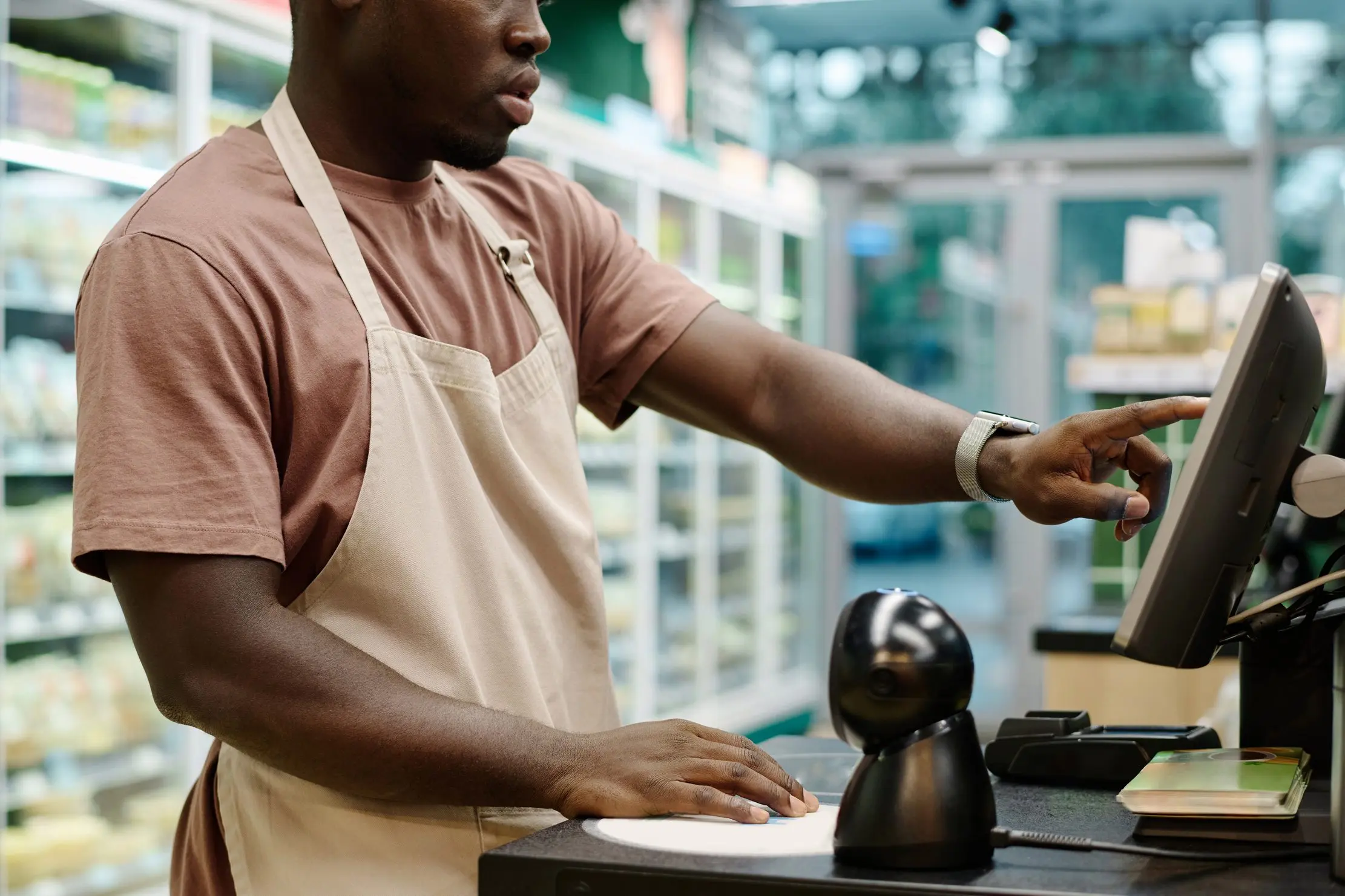 Cashier using a point-of-sale terminal during a supermarket sale