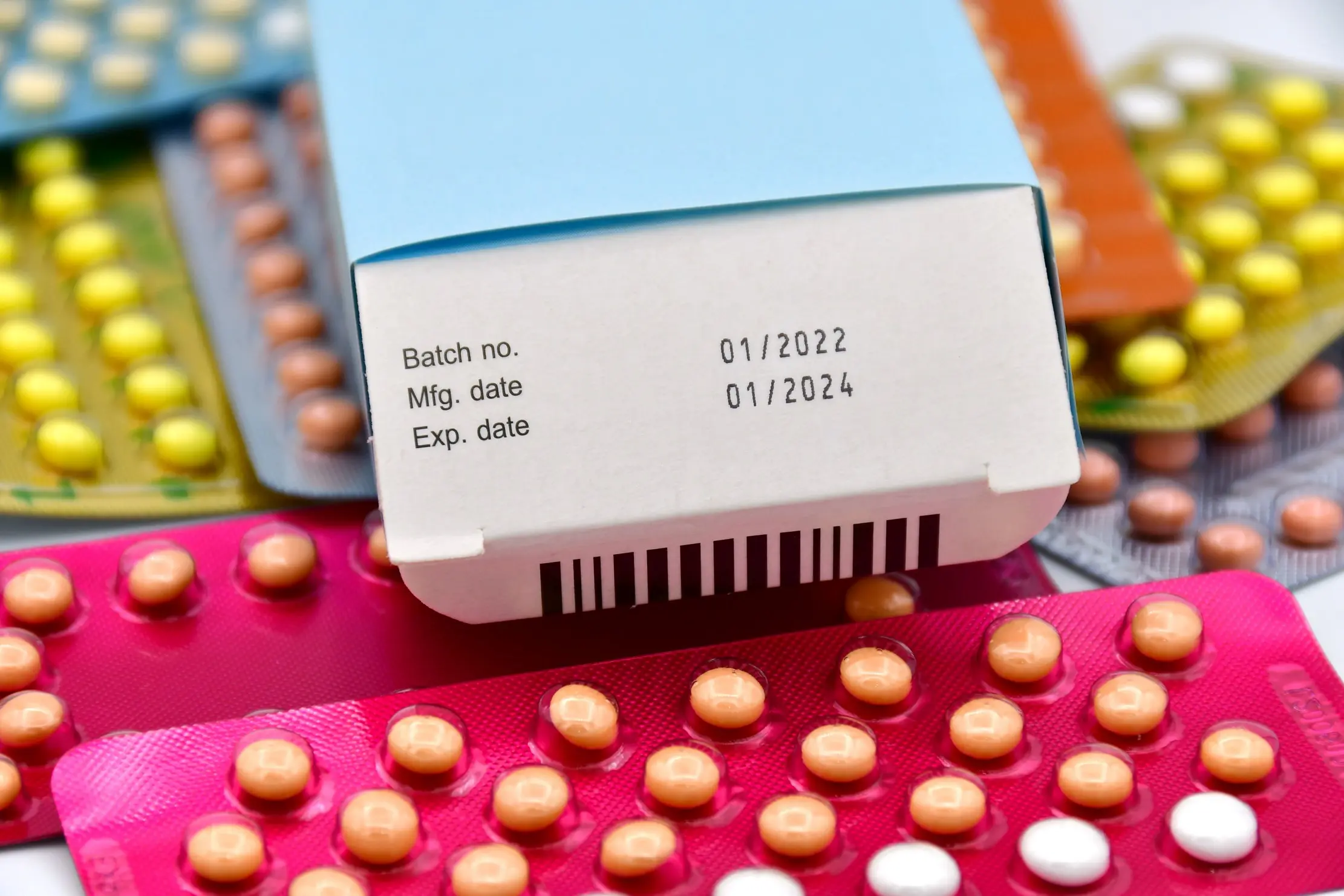 Close view of a medicine carton showing batch, manufacturing, and expiry date fields
