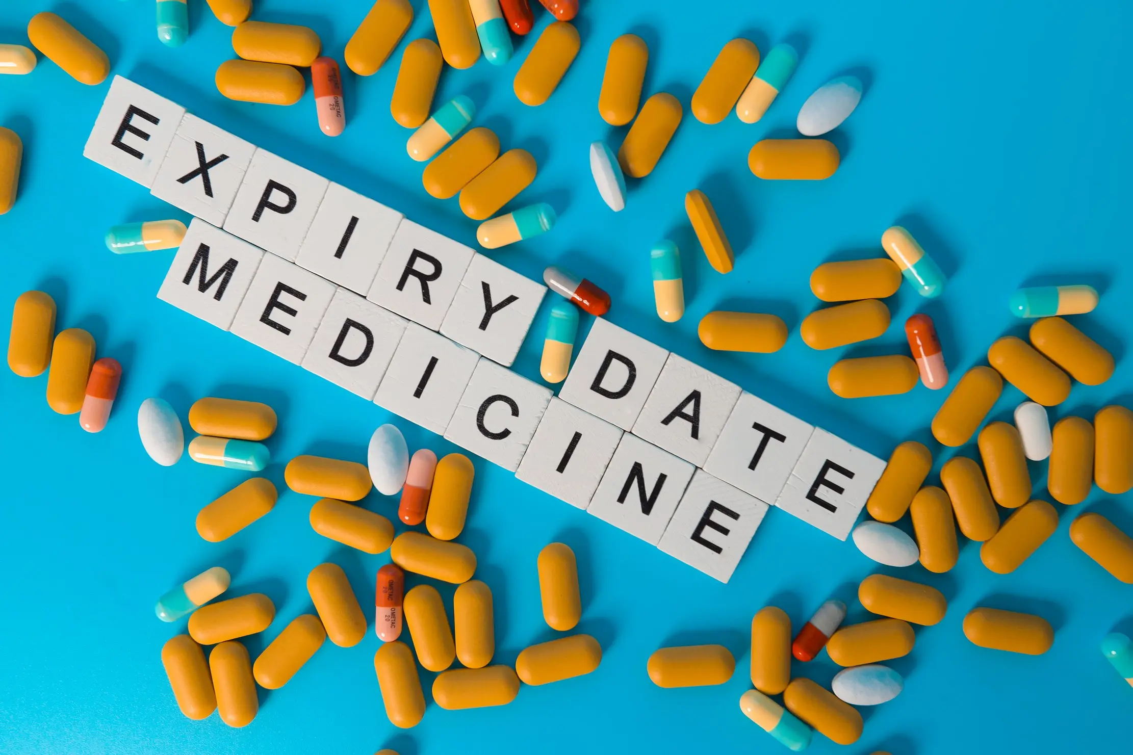 Medicine packs arranged around the words expiry date as a stock-control reminder