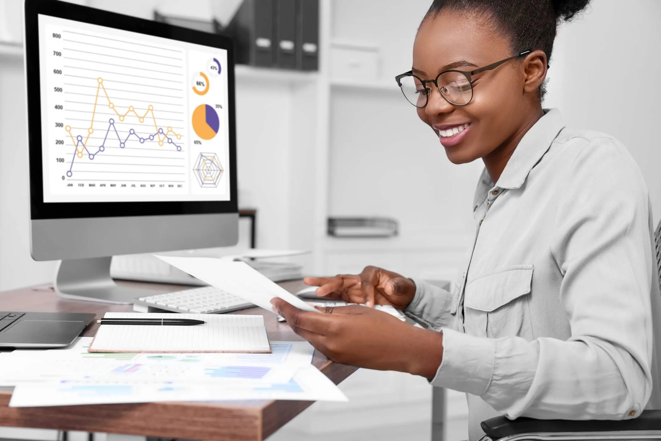 Professional accountant reviewing financial records at a wooden desk, representing auditor-ready reporting